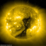 The black area on this false colour image of the sun is a coronal hole. Courtesty of SOHO (NASA/ESA)